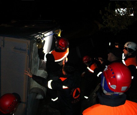Rescue workers at the overturned truck