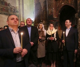 Government members holding candle lights inside a church