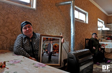 Zarangul Akhmedova holds picture of her son Pikrat, who was murdered shortly before New Year (DF Watch)