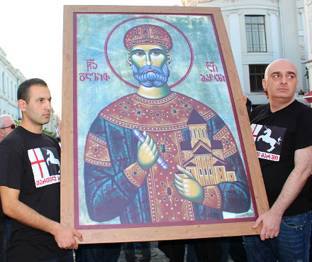 Sandro Bregadze (right) and supporters hold up a painting of Georgian King David IV